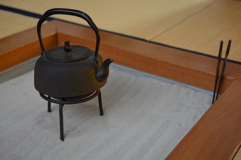 An iron cast kettle placed on a rack