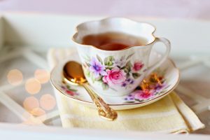 A cup with a floral design filled with tea