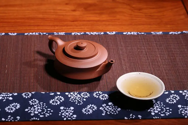 Yixing teapot and a cup of tea placed in a table
