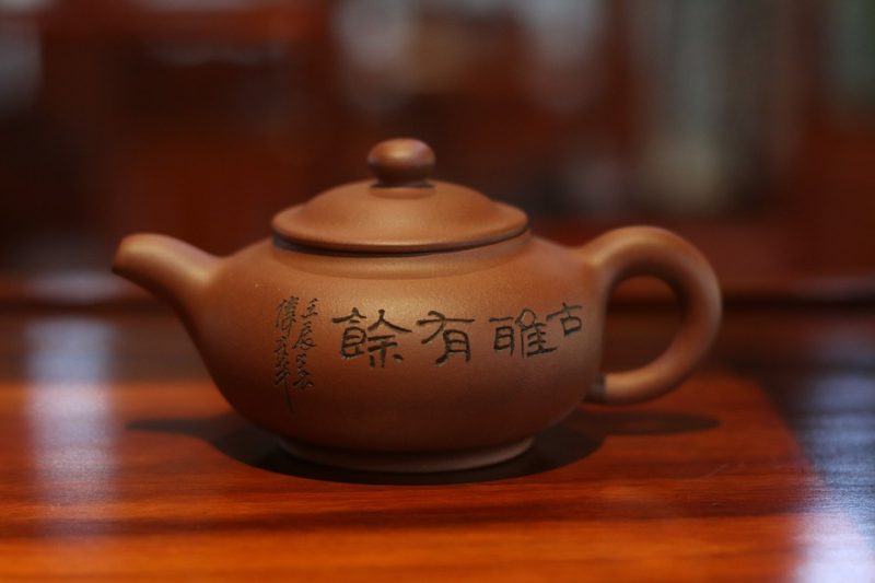 A traditional Yixing teapot on a wooden table