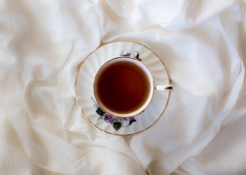 Tea filled white ceramic cup on a saucer