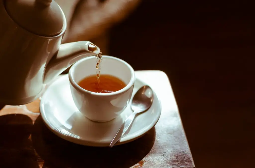 Pouring tea into a teacup 