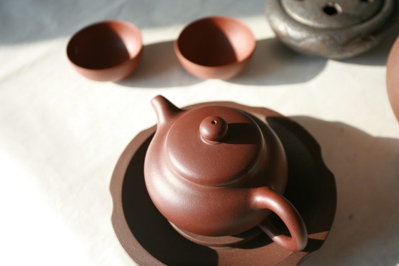A yixing teapot set on a white surface