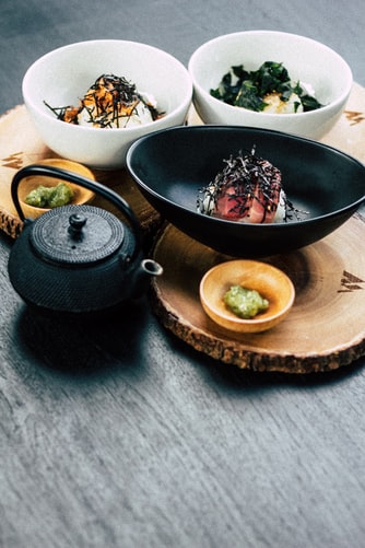 Cast iron teapot being served alongside a Japanese dinner set