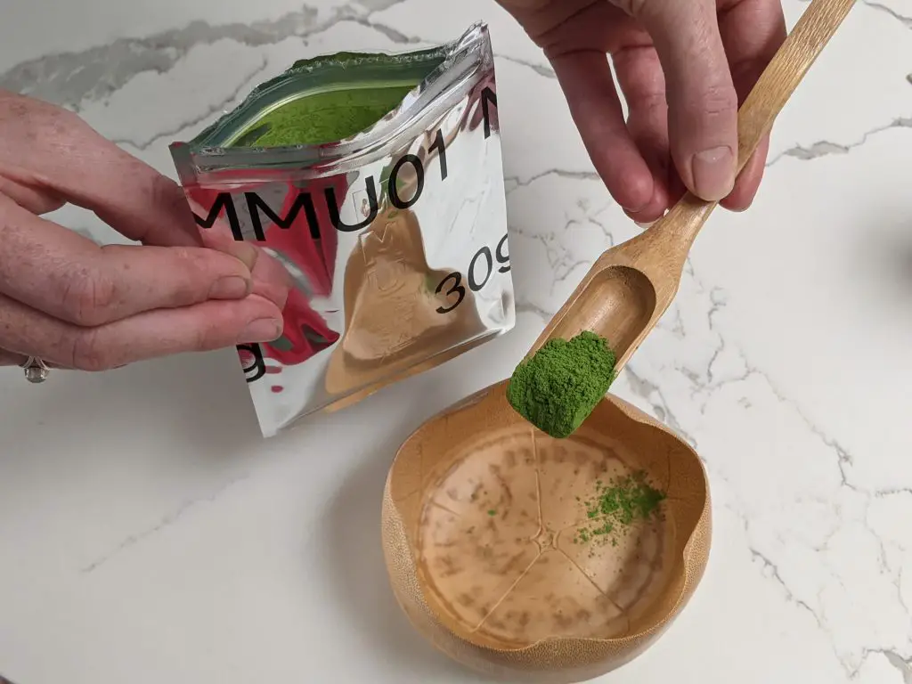 Person taking out the matcha tea powder from the Material Matcha Uji MMU01 sealed pack