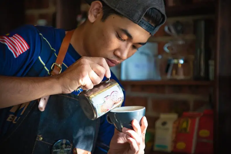 Man demonstrating how to make Japanese milk tea
