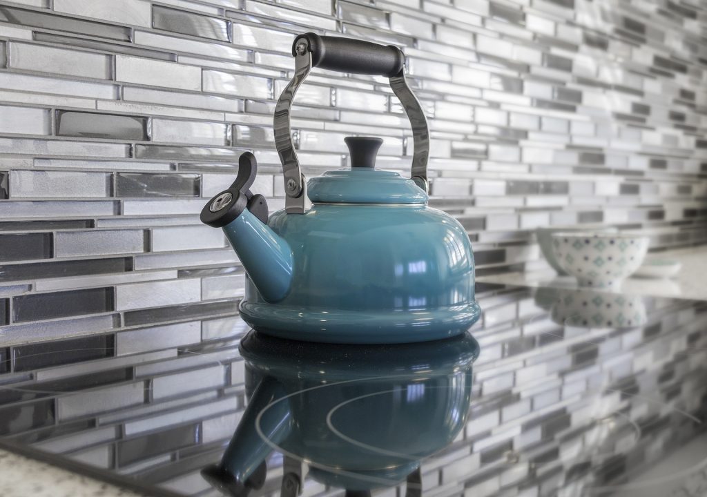 Blue tea kettle on a stove