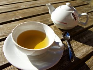 Ceramic teapot being used to warm tea