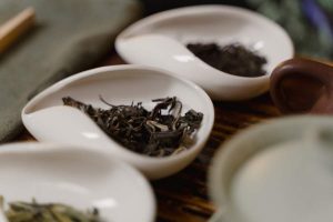 Black loose tea leaves on a white container