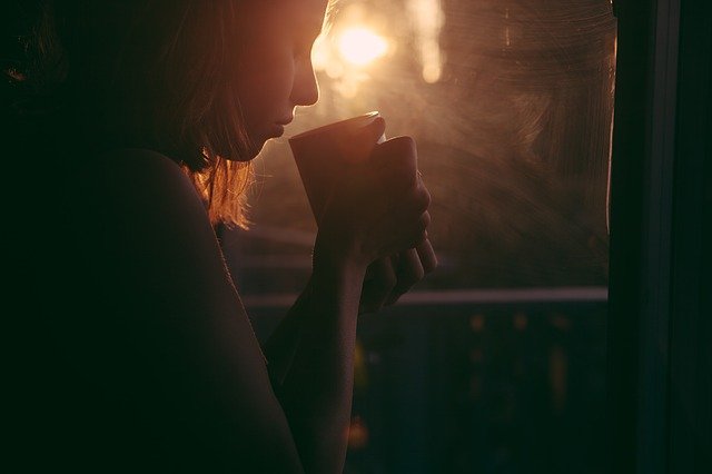 Woman Drinking Warm Tea to Help Ease Headache Pain